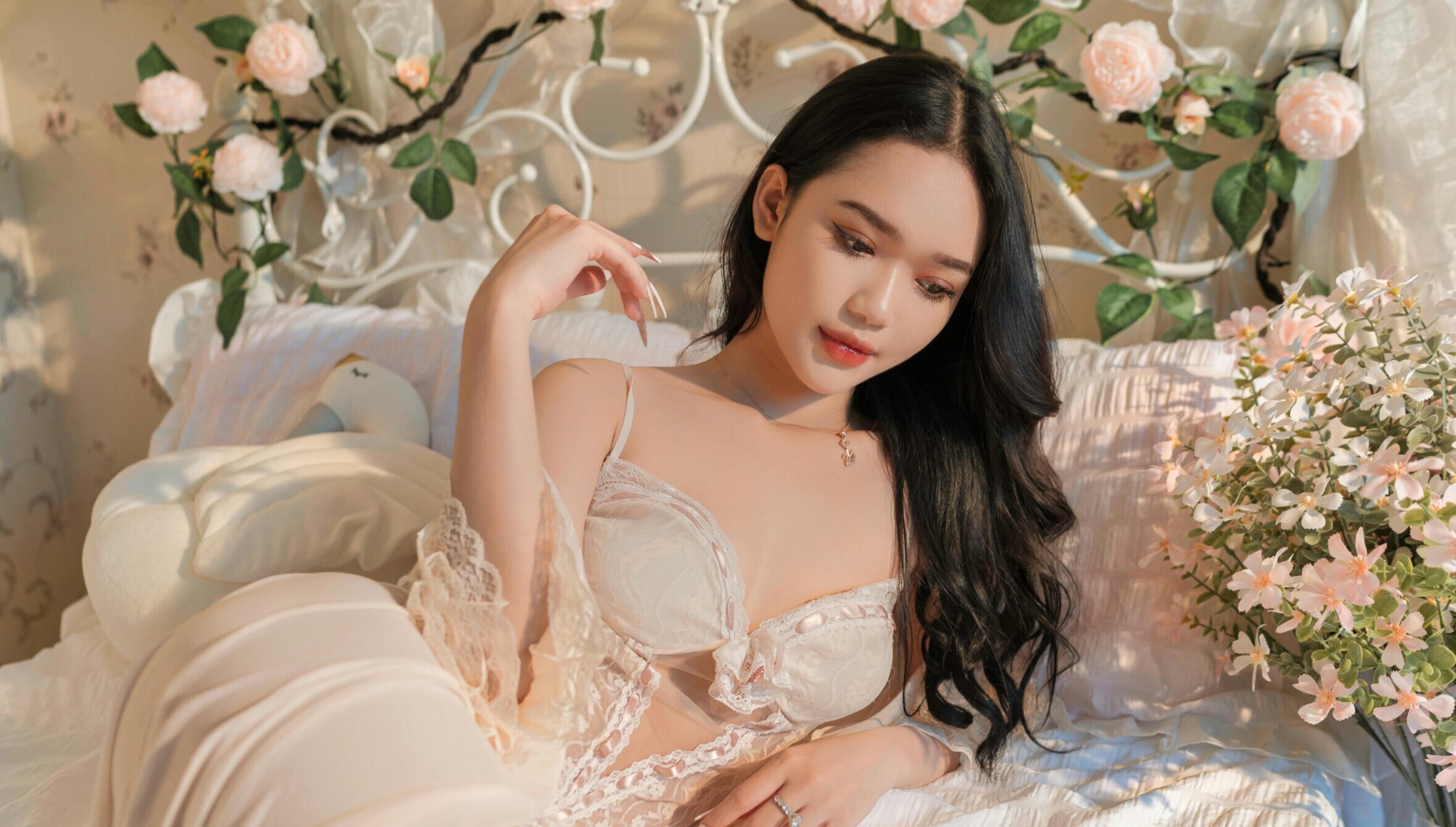Young woman in red outfit savoring a watermelon outdoors on a sunny day.